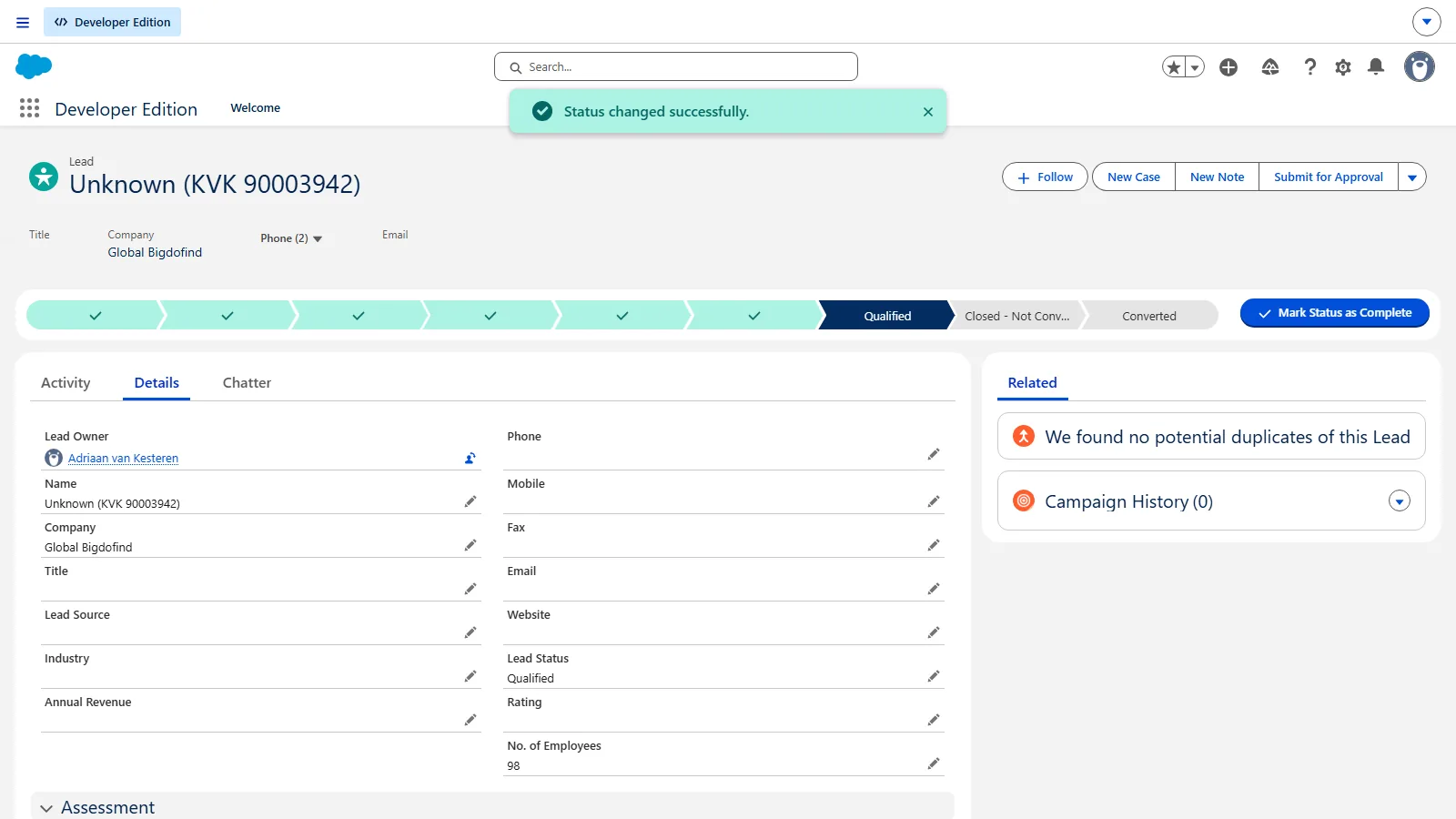 Salesforce after the status change: the path shows Qualified and a green confirmation says Status changed successfully.